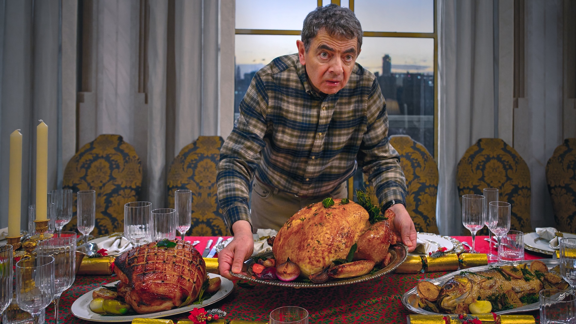 Rowan Atkinson in Man vs Baby holding a turkey 