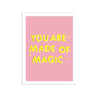 A pink wall art that says 'you are made of magic'
