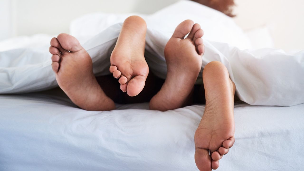 how to have good sex, couple&#039;s feet poking out from under sheets