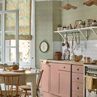 Green kitchen with wall paper and pink cabinets