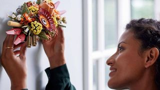 lego icons dried flowers centerpiece being placed on a wall