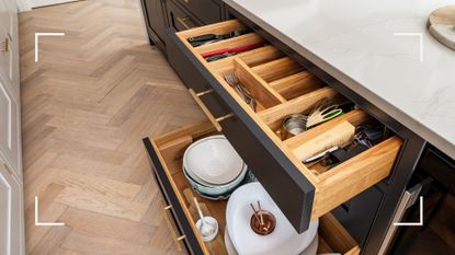 Kitchen with two low level drawers opening and showing how to organize kitchen drawers using wooden dividers