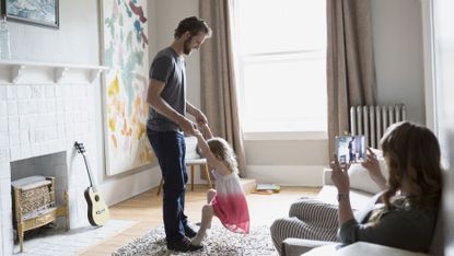 woman watching husband and kid