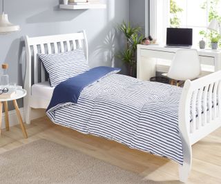 single bedroom with blue and white coverless duvet