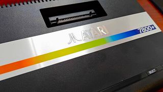 Close up of Atari 7800+ console logo and cartridge slot.