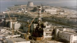 An aerial photo of a nuclear power plant with a red and white striped tower.