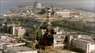 An aerial photo of a nuclear power plant with a red and white striped tower.