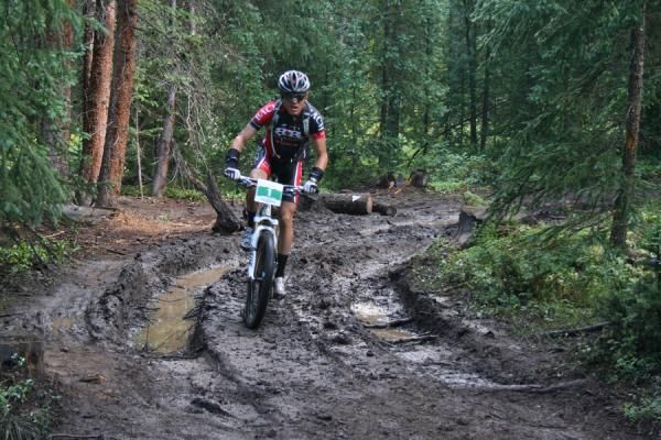 Josh Tostado (Bach Builders) leads the race through a muddy section of the Colorado Trail before Aid 1.