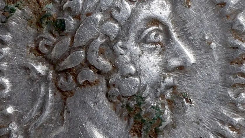 A close-up of a coin with the profile of a man