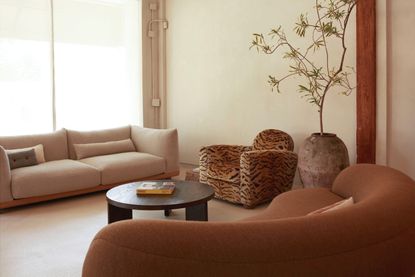 modern living room with terracotta hues and a leopard print chair