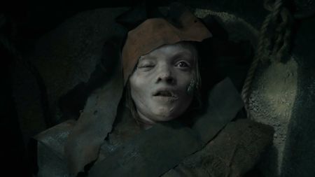 A young girl swaddled in rags awakening from death
