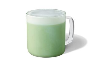 A glass mug of Starbucks Matcha Green Tea Latte with almond milk