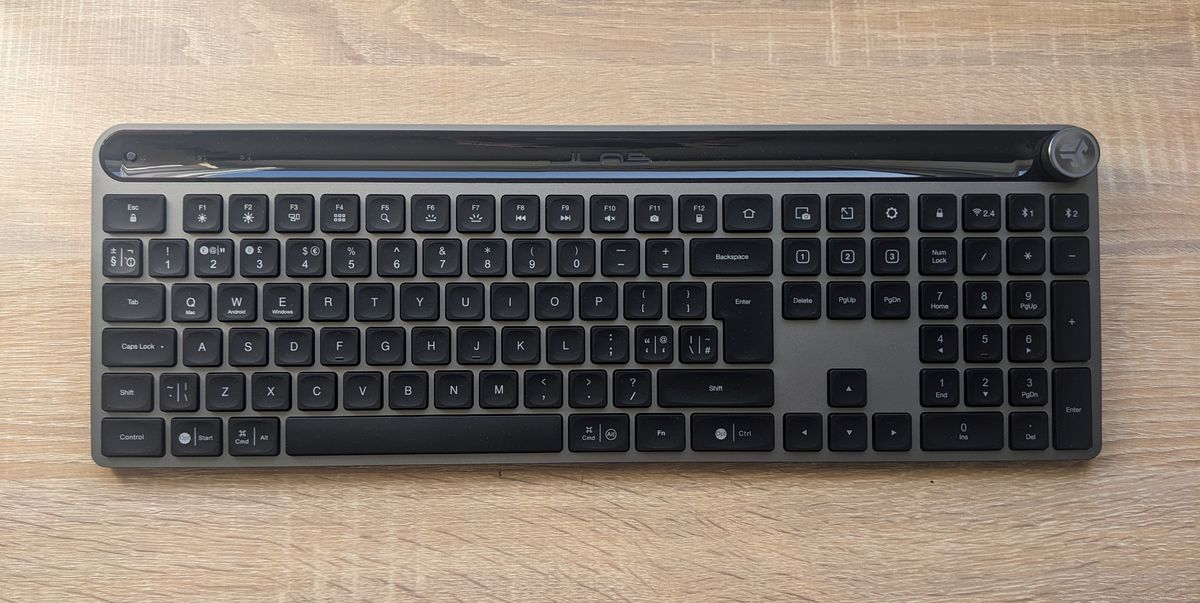 The JLab Epic Wireless Keyboard photographed on a wooden desk.