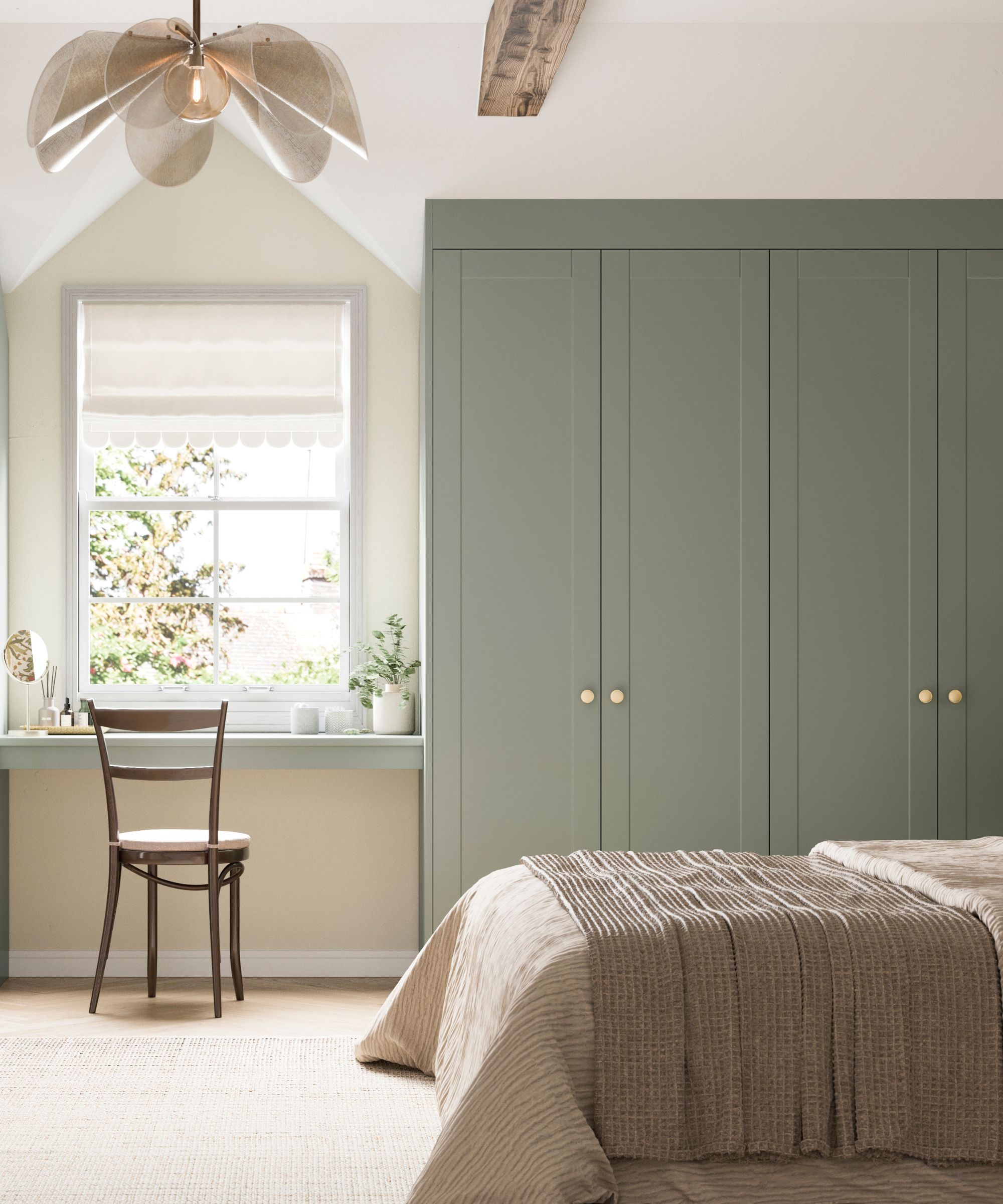Cream bedroom with carpet, sage green built-in closet and matching vanity table with mid century chair. There is a petal statement ceiling light and bright window showing trees beyond