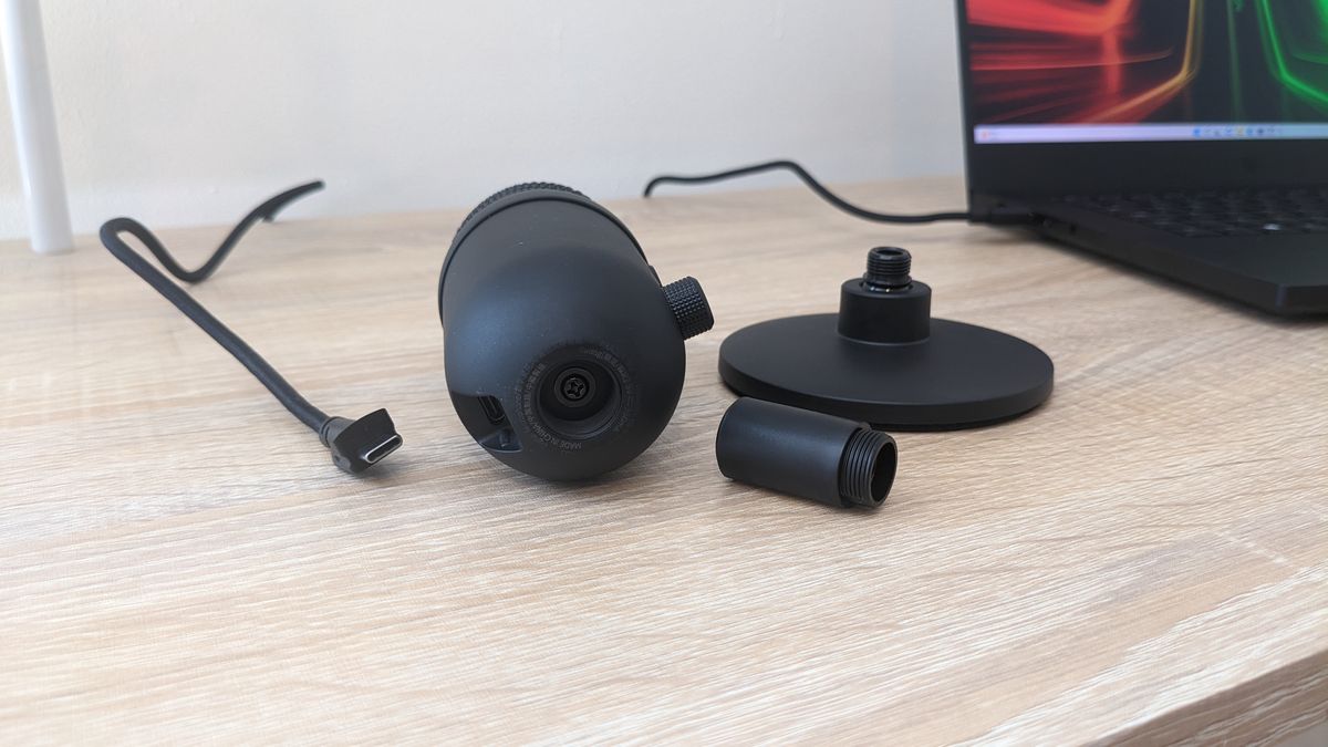 Razer Seiren V2 X USB microphone on a wooden desk, plugged into a Razer Blade 14 laptop.