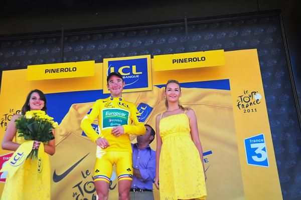 Thomas Voeckler (Europcar) dons the yellow jersey with assistance by 5-time Tour champion Bernard Hinault.