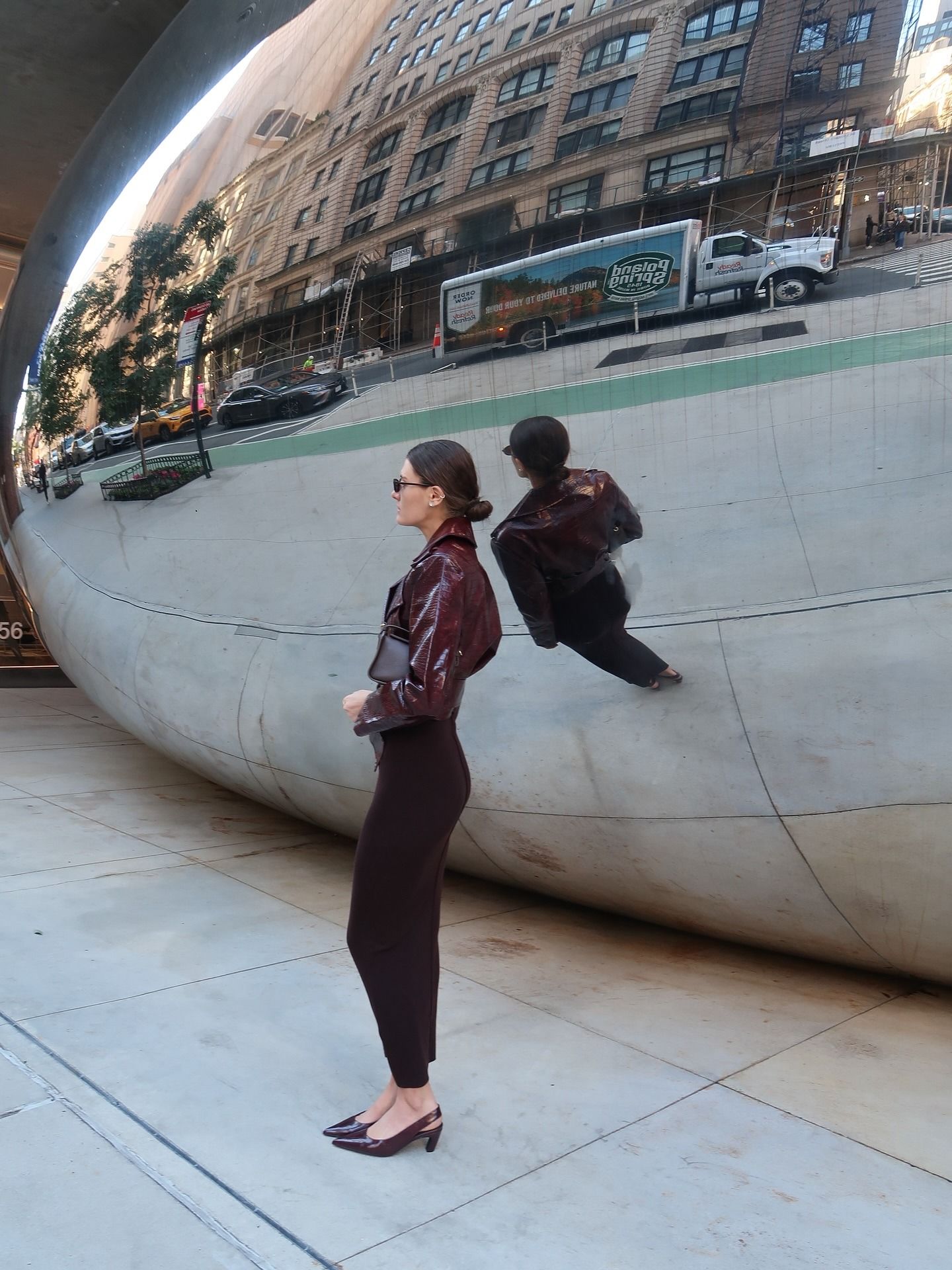 Influencer @cocoschiffer wears burgundy slingback heels with a burgundy leather jacket and a dark brown fitted skirt.
