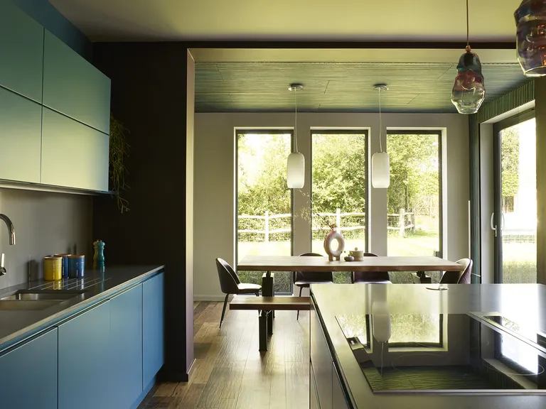 blue modern kitchen and open plan dining area