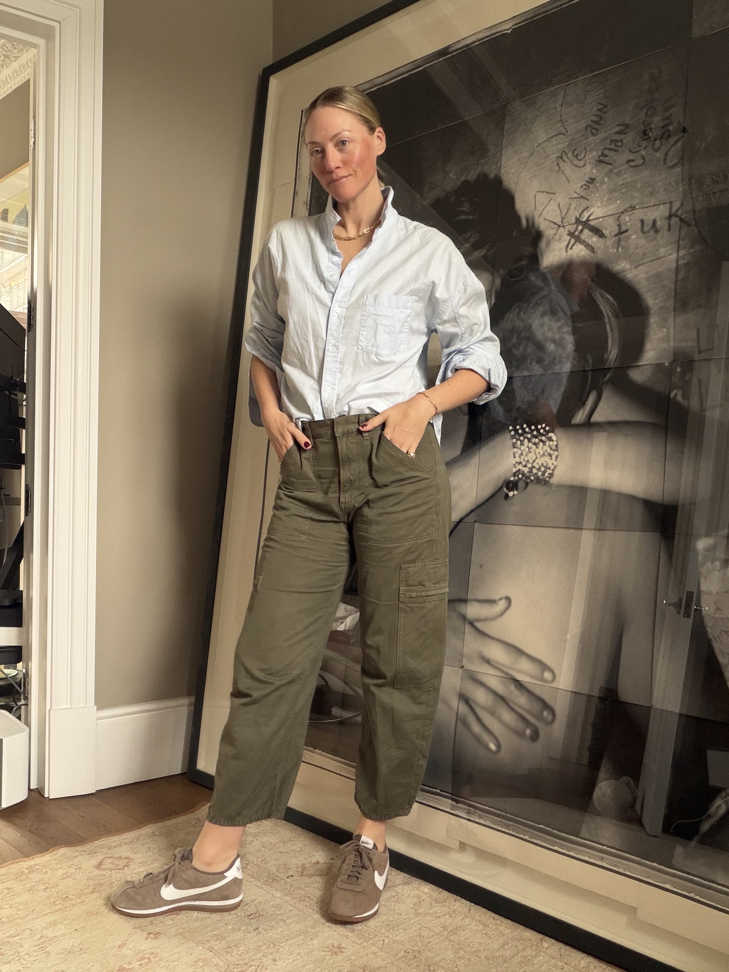 Brooke Ely Danielson styles her Nike Cortez sneakers with olive cargo pants and a pastel button-down