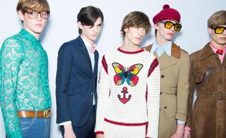 Group of male models lined up wearing colourful & decorative clothing