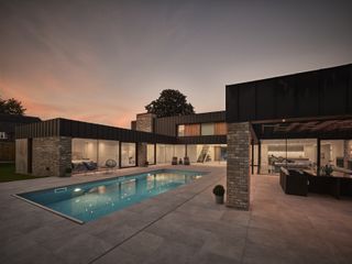 contemporary outdoor swimming pool in courtyard of modern self build