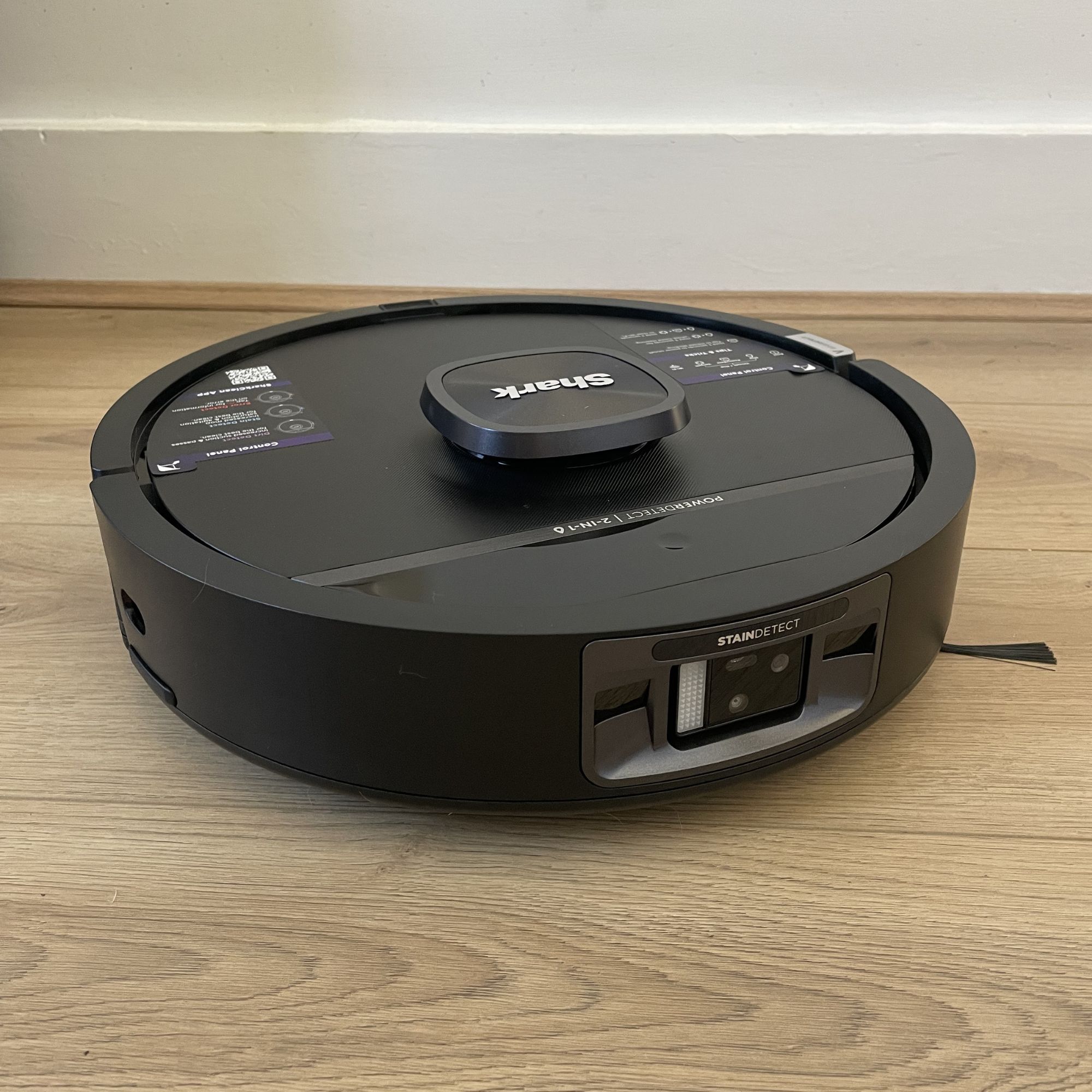 Bot of the Shark PowerDetect UV Reveal 2-in-1 Vac & Mop Robot Vacuum RV3000XEUK sitting on wood-effect flooring
