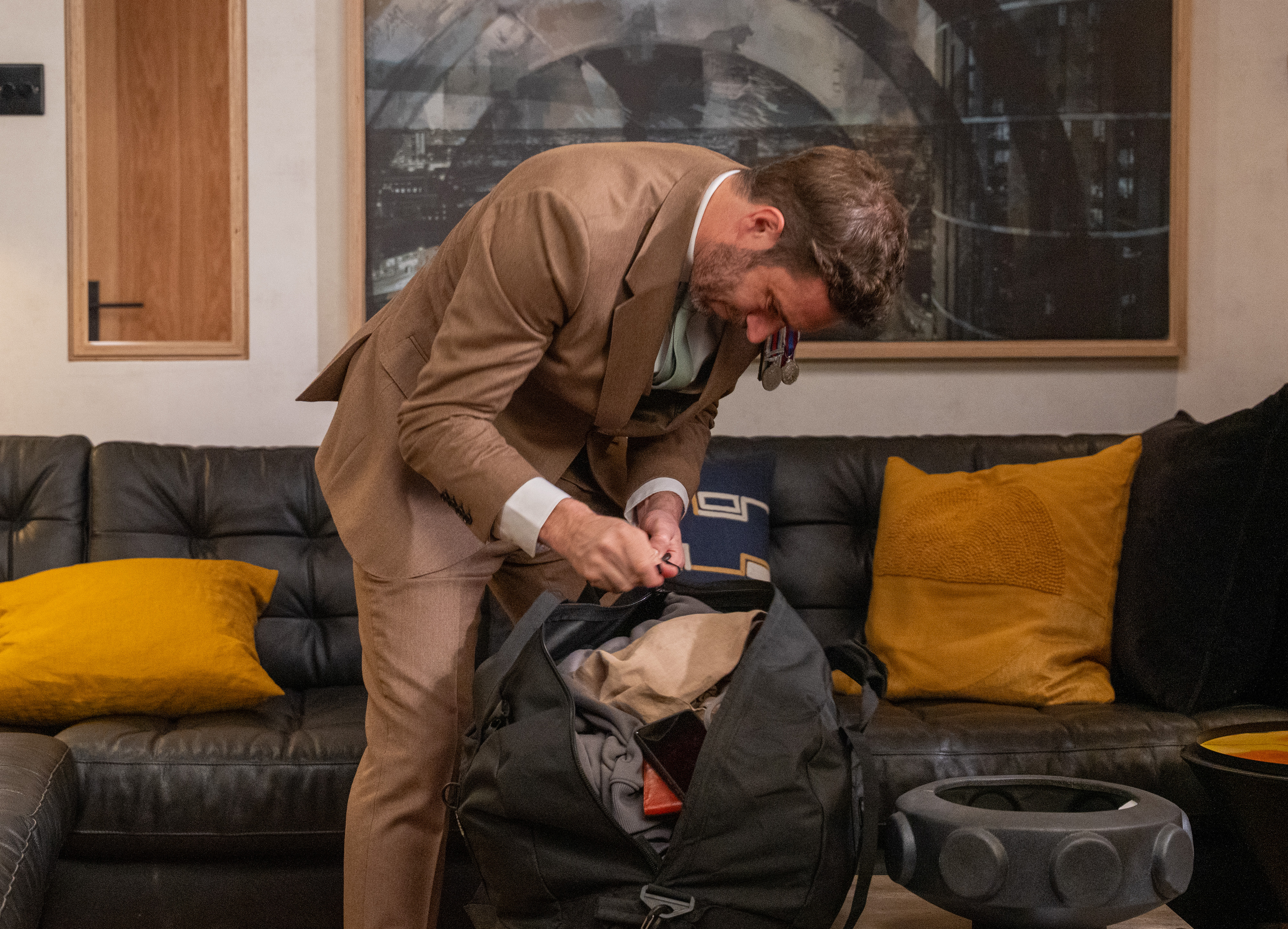 John packs and prepares to run off