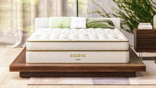 Best mattress 2022: image shows the Saatva classic luxury innerspring mattress on a low wooden frame, in a stylish bedroom