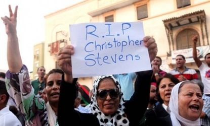 A demonstrator holds a sign during a rally in Benghazi