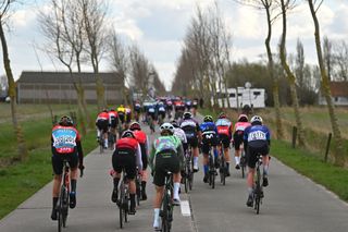 WEVELGEM, BELGIUM - MARCH 24: A general view of the peloton competing during the 13rd Gent-Wevelgem in Flanders Fields 2024, Women's Elite a 171.2km one day race from Ieper to Wevelgem / #UCIWWT / on March 24, 2024 in Wevelgem, Belgium. (Photo by Luc Claessen/Getty Images)