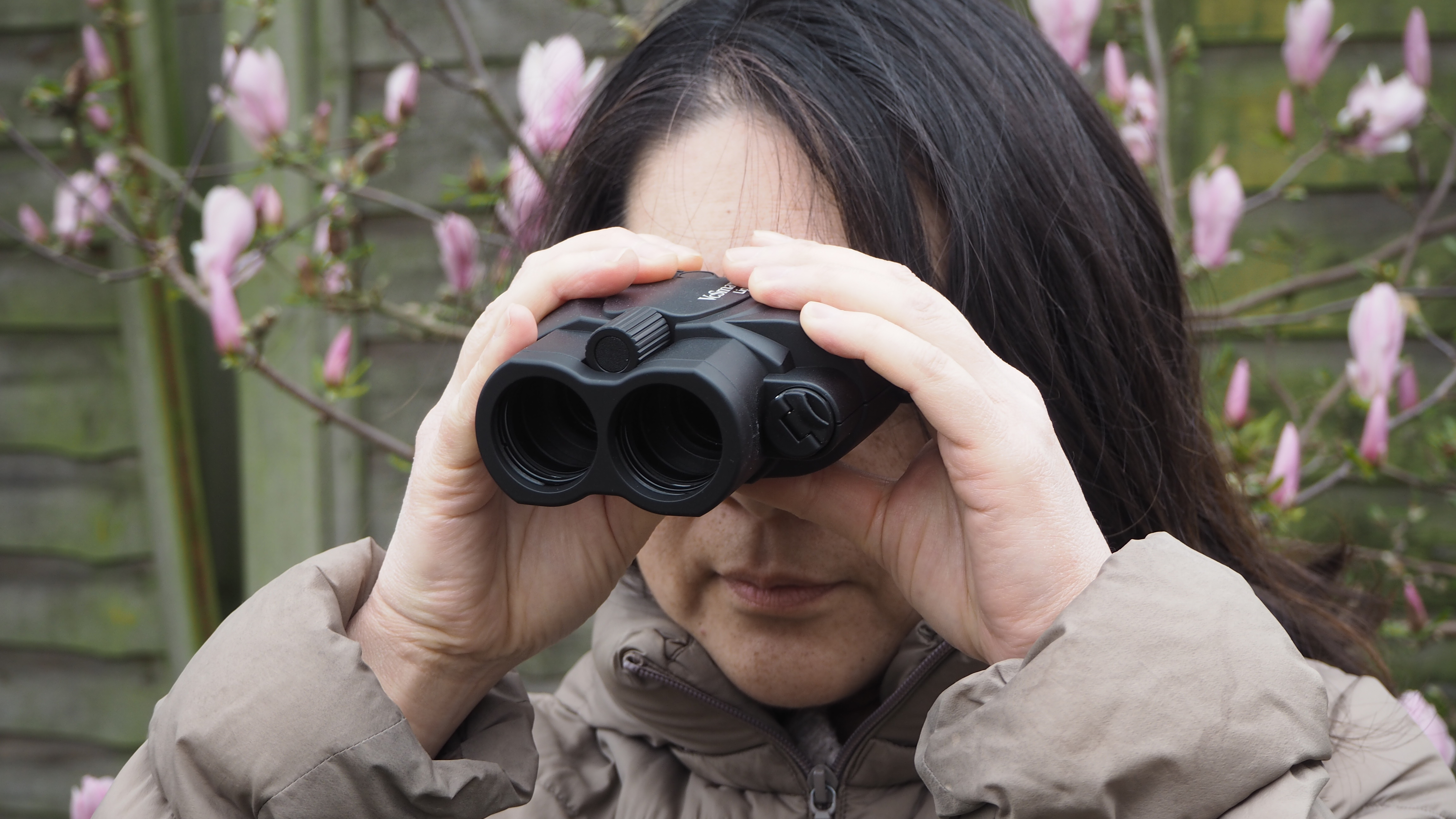 Kenko Vc Smart 14x30 Light binoculars handheld with a person looking through them