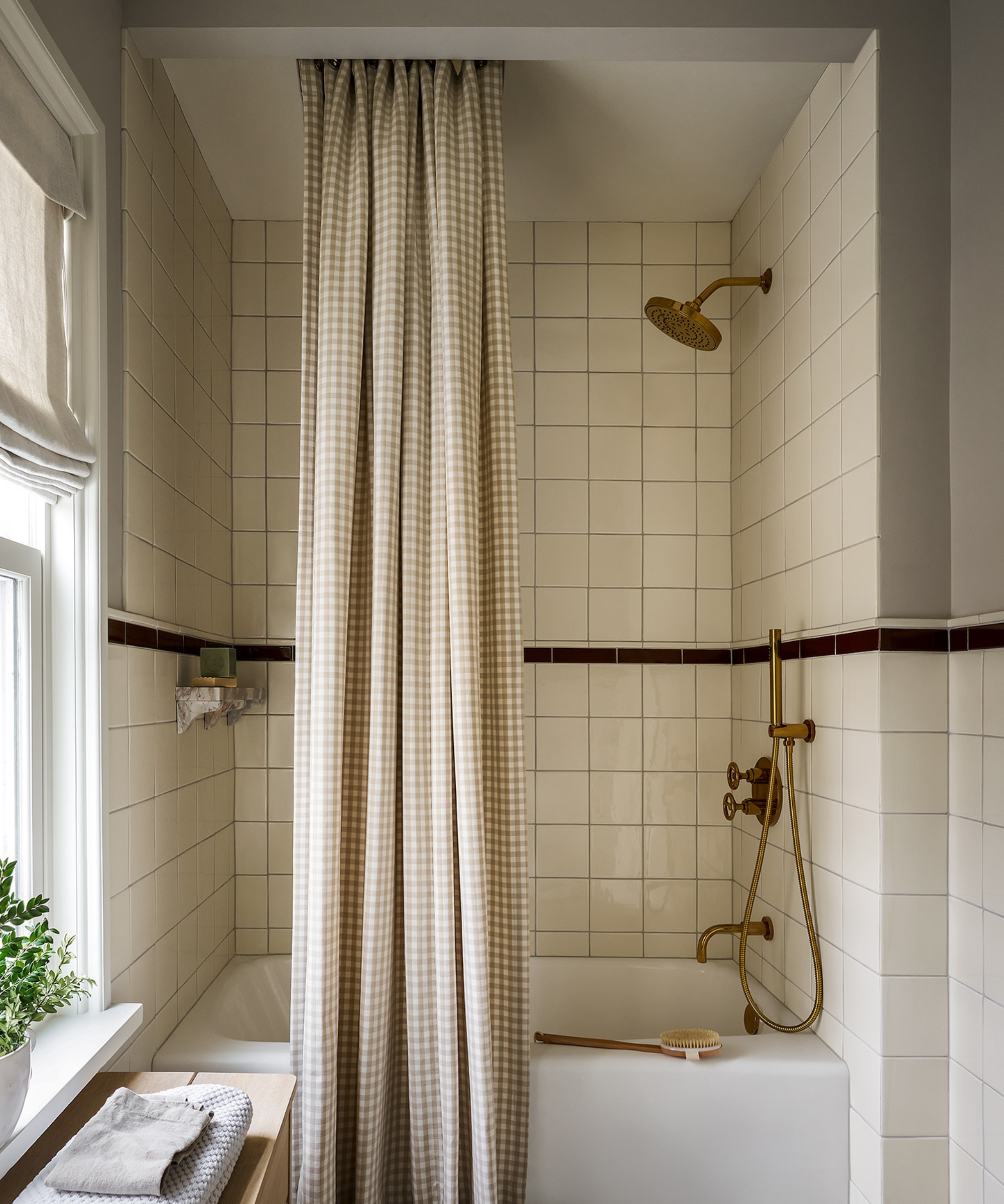 A neutral bathroom with the shower curtain hung from the ceiling