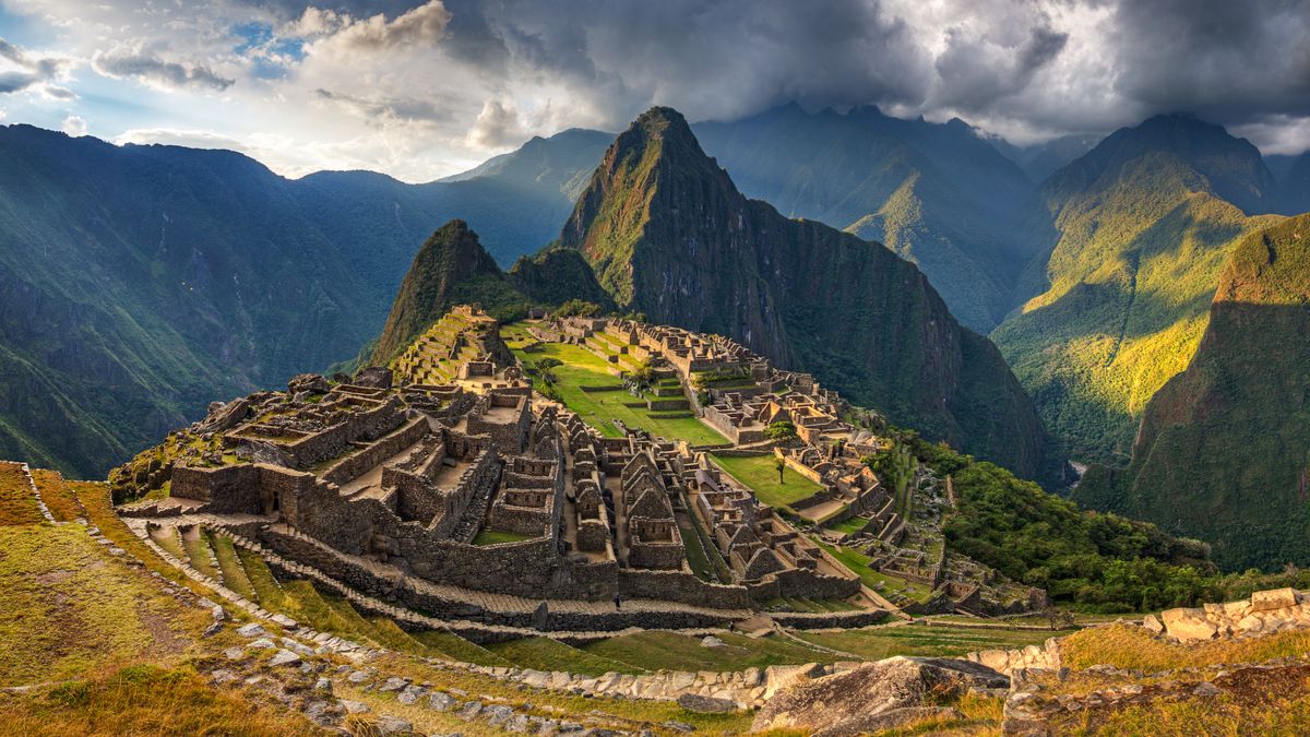 A view of Machu Picchu&#039;s rocky ruins from a mountaintop. 