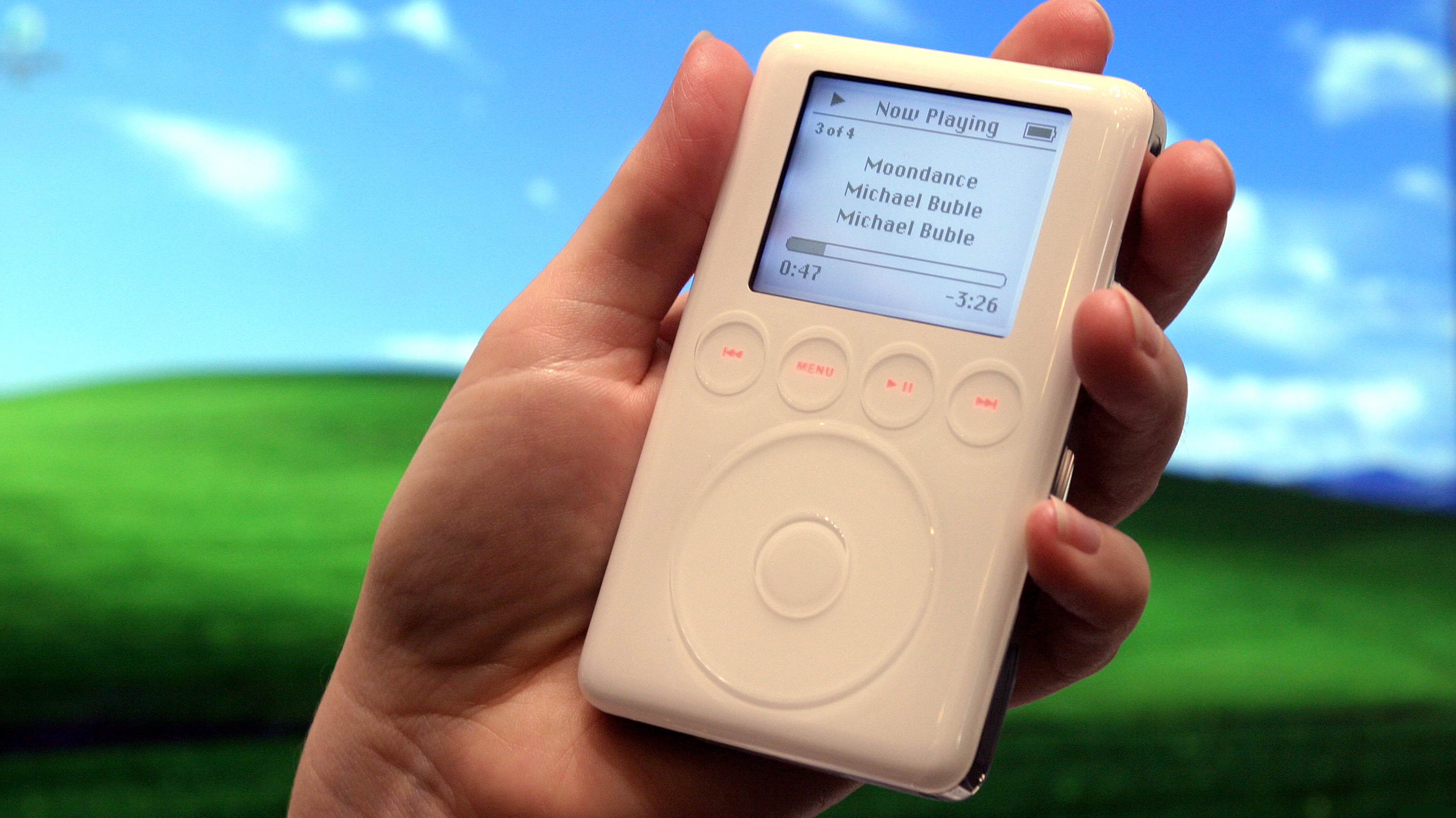 A hand holding a third-gen iPod