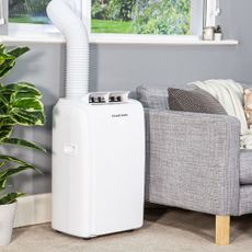 Russell Hobbs portable air conditioner next to grey couch