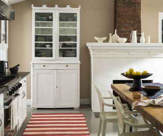 Cottage kitchen with beige walls and an exposed brick chimney breast