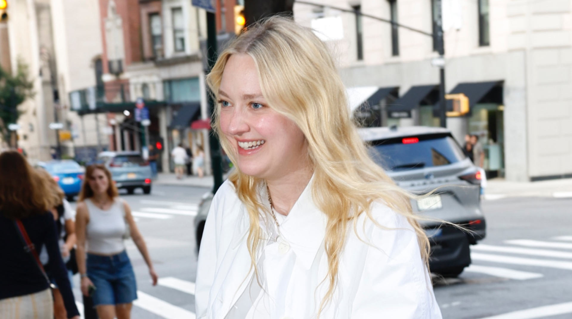 Dakota Fanning wears dark jeans, heeled flip flops, an oversize white shirt to Ralph Lauren