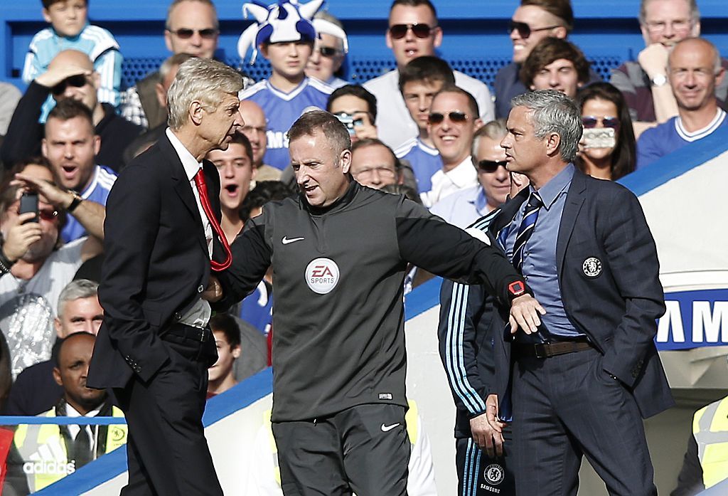 Chelsea&#039;s Portuguese manager Jose Mourinho (R) and Arsenal&#039;s French manager Arsene Wenger (L) are kept apart by the fourth official Jonathan Moss during the English Premier League football match between Chelsea and Arsenal at Stamford Bridge in London on October 5, 2014. AFP PHOTO/ADRIAN DENNIS == RESTRICTED TO EDITORIAL USE. NO USE WITH UNAUTHORIZED AUDIO, VIDEO, DATA, FIXTURE LISTS, CLUB/LEAGUE LOGOS OR &quot;LIVE&quot; SERVICES. ONLINE IN-MATCH USE LIMITED TO 45 IMAGES, NO VIDEO EMULATION. NO USE IN BETTING, GAMES OR SINGLE CLUB/LEAGUE/PLAYER PUBLICATIONS. == (Photo credit should read ADRIAN DENNIS/AFP via Getty Images)