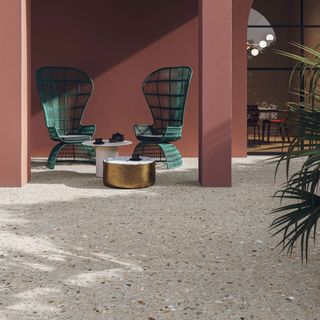 patio area with green chairs and porcelain tiles