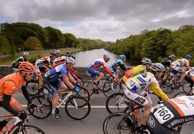 The peloton cross the bridge on the way out of Listowel