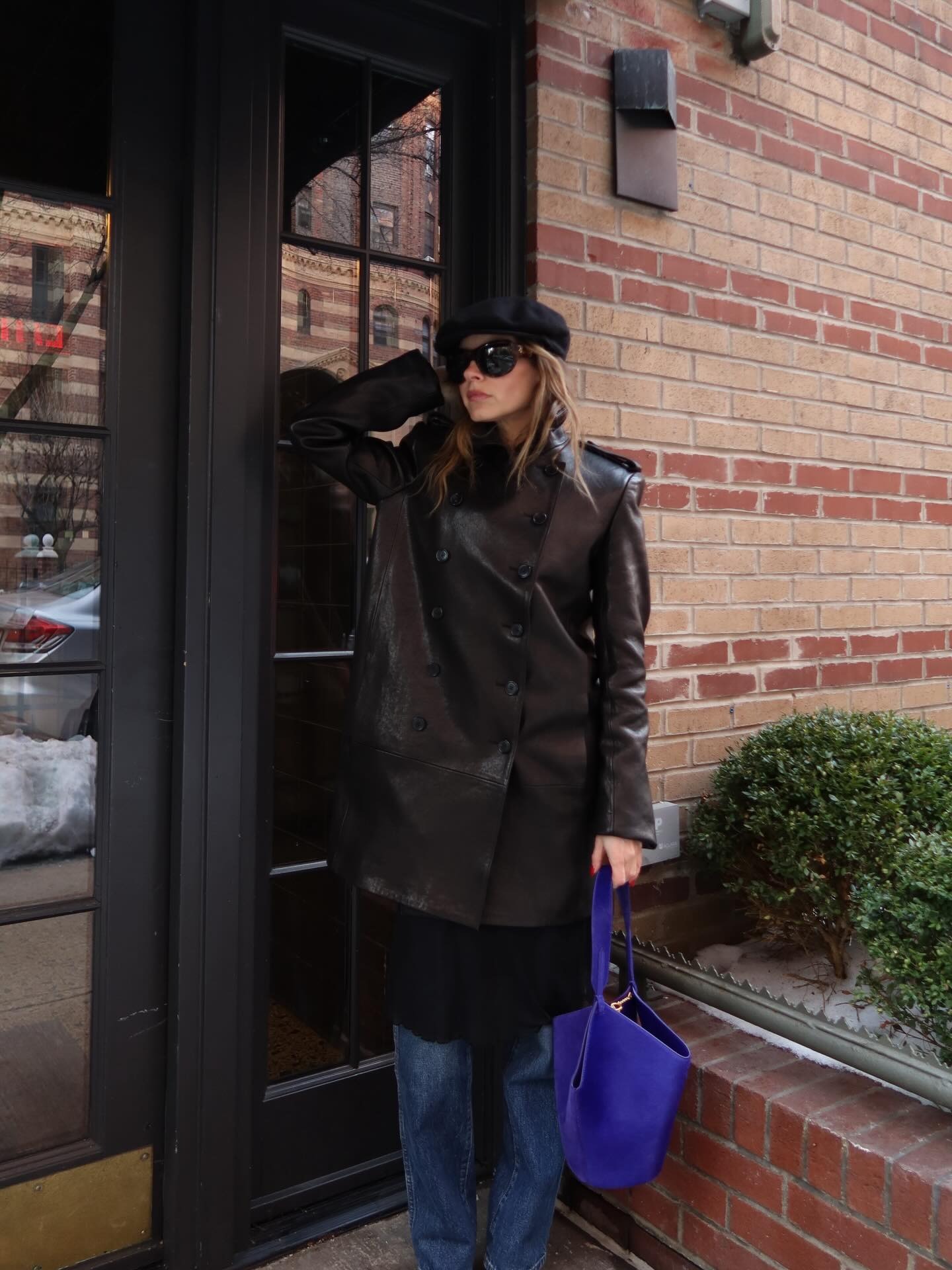 Woman wearing colorful handbag, a 2026 trend.