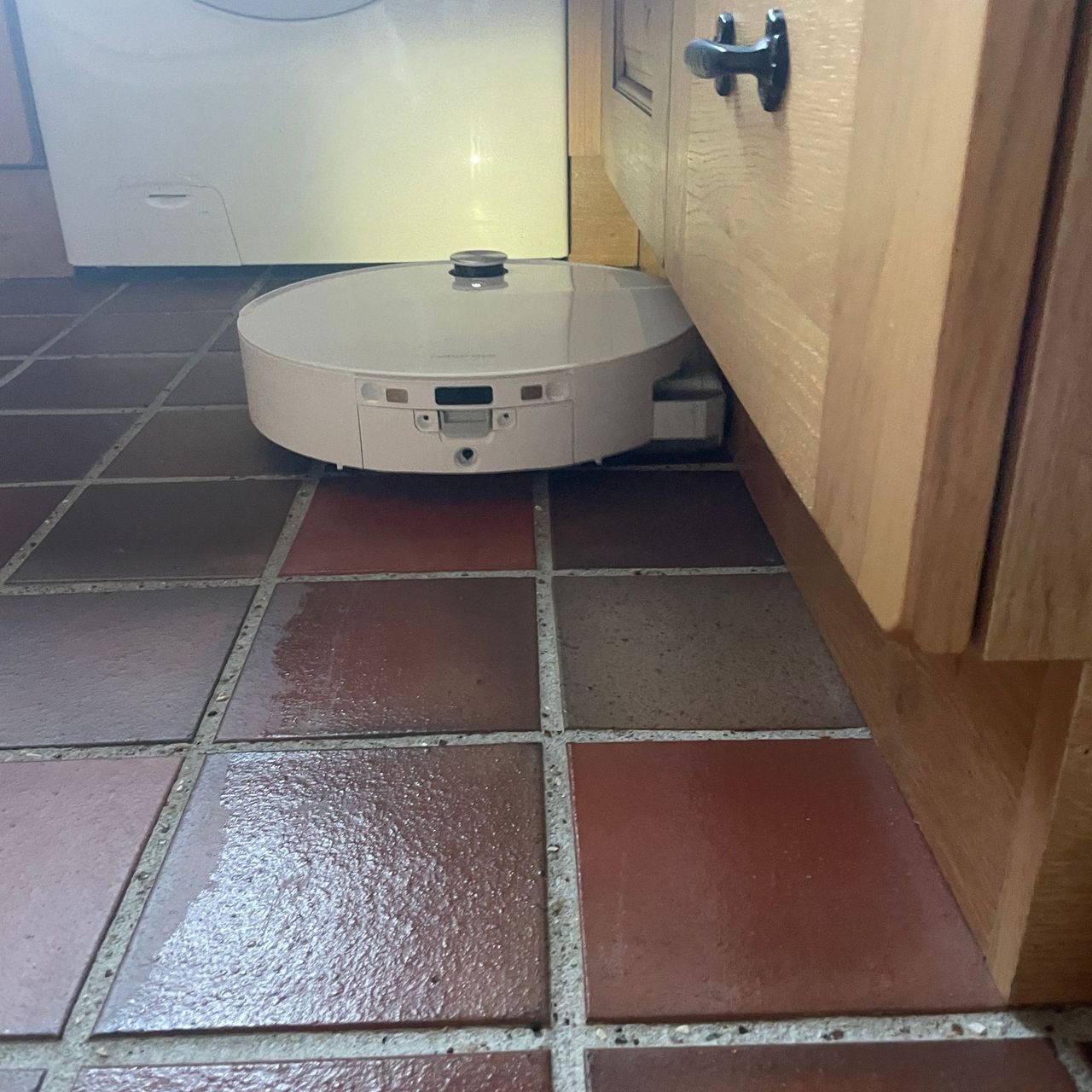Roborock Qrevo Edge 2 Flow Robot Vacuum cleaning brown stone tiles in a kitchen