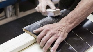 a worker sanding a sonus faber speaker