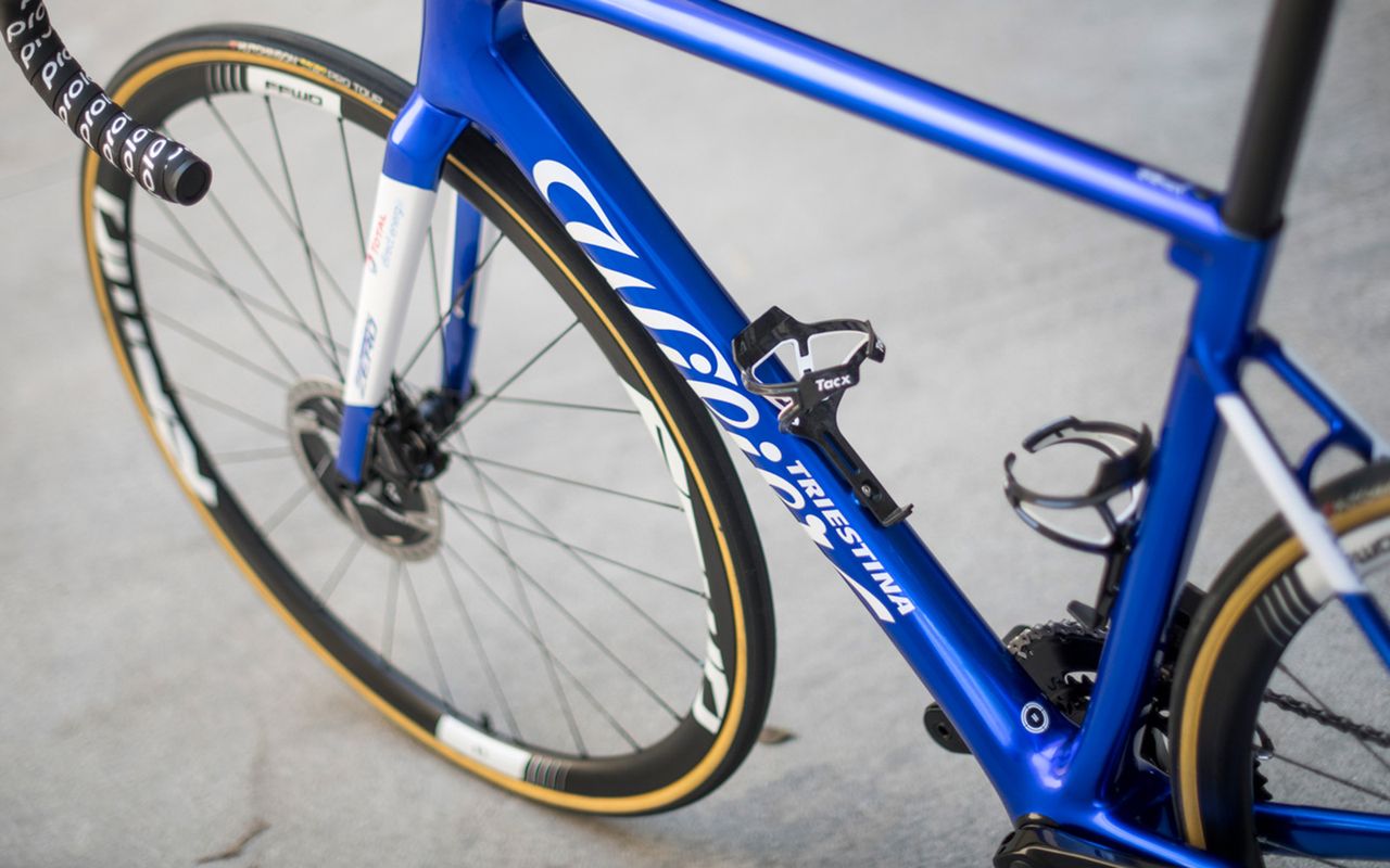 The frame features a shiny blue paint design with contrasting white decals