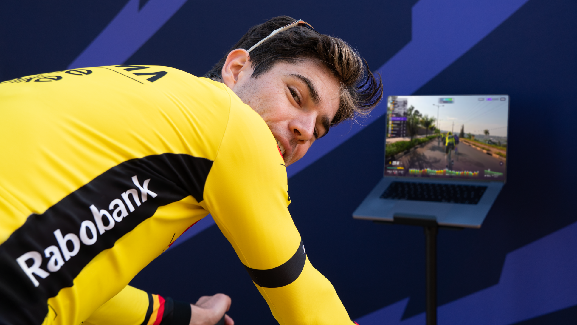 Wout van Aert looks over his shoulder in front of a screen showing the ROUVY app