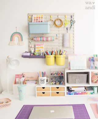 White desk with colorful accessories