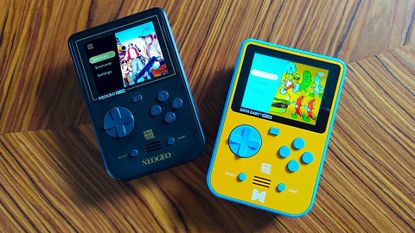 Neo Geo and Data East Super Pocket handhelds on woodgrain table.