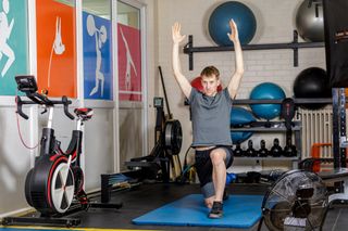 Male cyclist holding a lunge as part of a bone health boosting routine