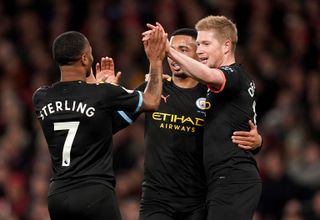 Manchester City’s Raheem Sterling (left) celebrates scoring his side’s second goal of the game with team-mates Gabriel Jesus (centre) and Kevin De Bruyne during the Premier League match at The Emirates Stadium, London