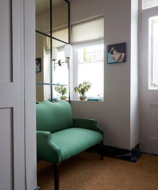 Green sofa, black framed window